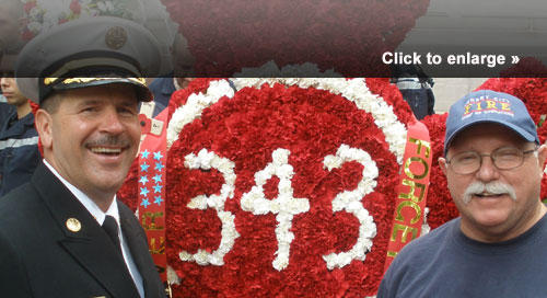Butch Cobb (right) meets with Michael Bryant, assistant chief of the Los Angeles County Fire Department, in front of the memorial commemorating the 343 FDNY firefighters who lost their lives that day.
